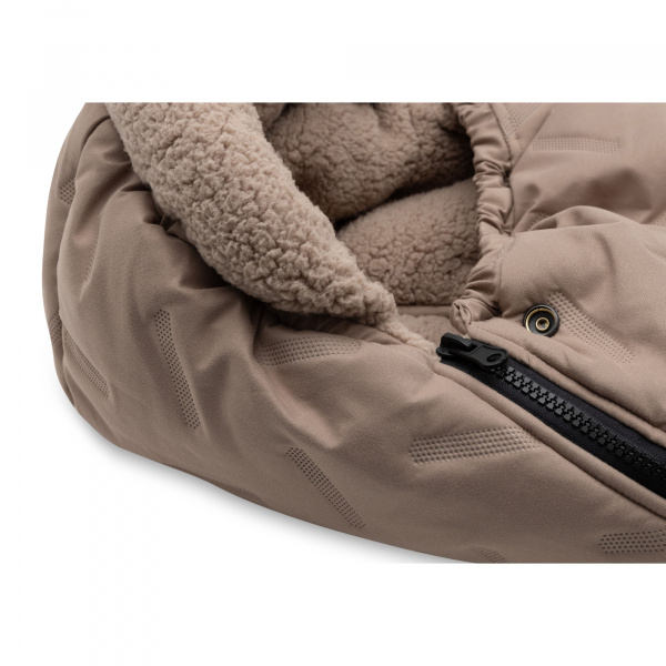 Nid d’ange groupe 0+ passe-sangle bébé embossed sand Jollein